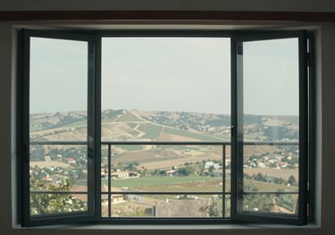 Photography of a folding glass balcony system fully opened, showing how it maximizes the view of the Anatolian landscape.