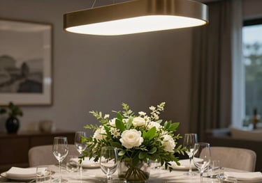 A beautifully decorated dining area with a modern light fixture, elegant table setting, and fresh greenery, professional real estate photography style.