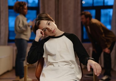a woman sitting in a chair with a man in a chair