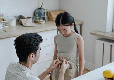 a man and woman standing in a kitchen