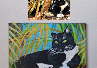 cat sitting under palm tree