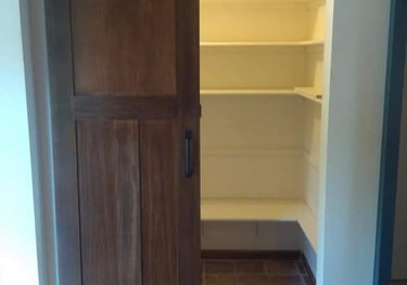a door with a sliding door and a pantry