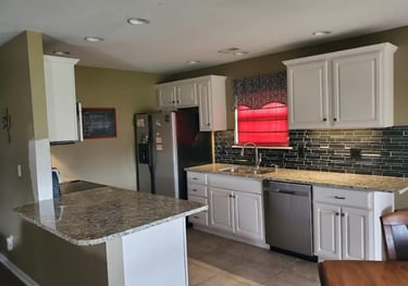 a kitchen with a table and chairs and a table