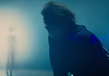 Older Self scene of an Individual approaching Tom Michaels from the light