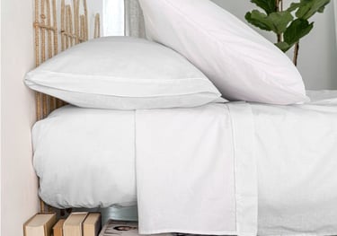 Stack of durable hotel pillowcases for commercial laundry