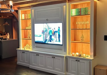 A book case and media unit with sunken flat screen tv