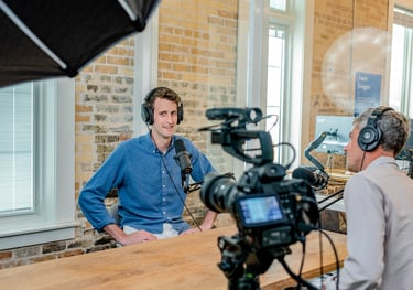 a man in headphones and headphones is recording a video camera - Swrill