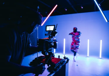 a man in a red shirt is standing in front of a camera - Swrill