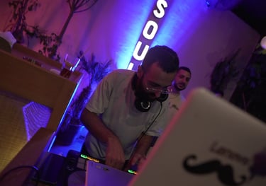 a man in a white shirt is djing for a hip hop party in beirut lebanon