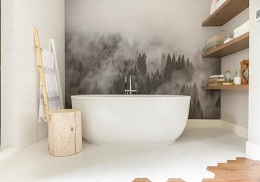 Modern bathroom with a white soaking tub and a misty forest wall mural.