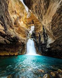 a waterfall in the middle of a canyon