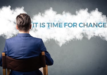 a man sitting in a chair with a cloud in the background