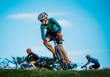 A cyclist turning on a steep bank in a cyclocross race