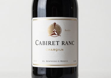 Photography of a Cabernet Franc bottle, labels featuring classic elegant typography, positioned against a clean white backdrop.