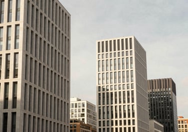 A high-end travel photograph of a modern cityscape in Europe, with sharp lines and sophisticated lighting in soft off-white and warm tan.