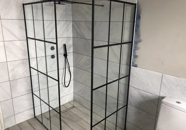 Modern walk-in shower installation with glass enclosure during bathroom renovation in Brighton.