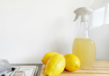 Lemons and a spray bottle full of DIY cleaner