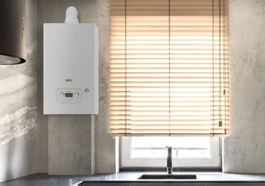 A white Baxi wall-mounted combi boiler installed in a modern kitchen next to a window with blinds