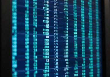 An abstract close-up of digital data streams on a server screen with deep blue and teal tones, representing computational breakthroughs.