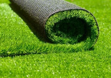 A roll of vibrant green artificial grass turf being installed for a low-maintenance lawn.