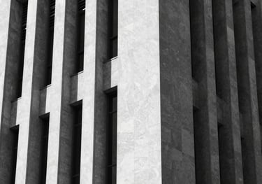 A high-contrast black and white photo of architectural lines of a modern church, emphasizing integrity and structure. Elements of #1A1A1A and #F8F4F0.