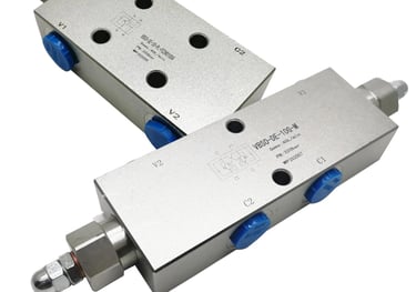 Two stainless steel valves with blue handles, secured by a safety valve lock, guaranteeing superior safety by locking the oil