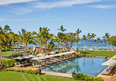 a pool with lounge chairs and umbrellas