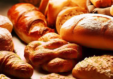 a bunch of breaded bread rolls on a table