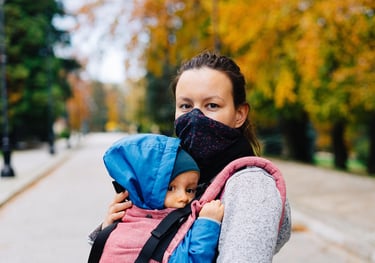 mom holding toddler, sharing stories, smiling at home