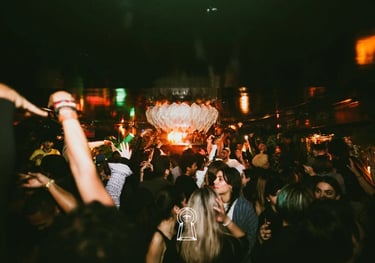 a crowd of people standing around a large fountain
