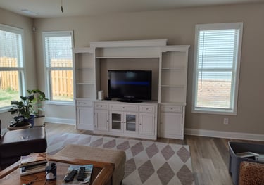 Professional living room furniture assembly with sofa, coffee table, and TV stand in a North Atlanta