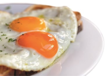a plate of eggs on toasted toasted bread