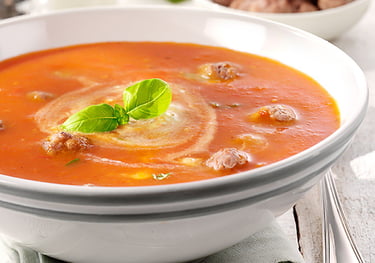 a bowl of soup with a slice of bread on top