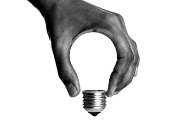 Creations and Solutions: a person holding a light bulb in their hand