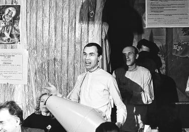 a man in a suit and tie is holding a giant inflatable balloon