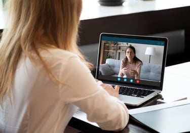 A photo of a coach conducting a 1 on 1 video teleconference call with an athelete