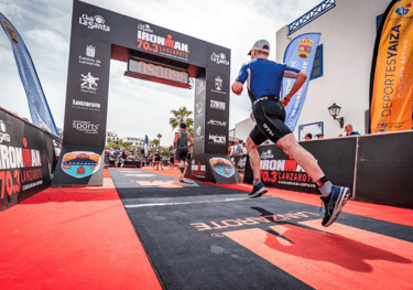 A photo of an Ironman 70.3 athlete crossing the finish line of the running event