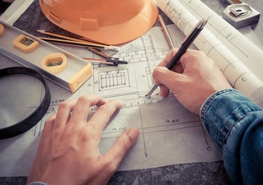 a person is holding a pen and writing on a paper