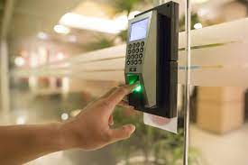 a person is pressing a button on a glass door