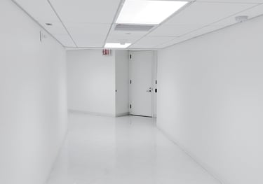 a hallway with a door leading to a white room