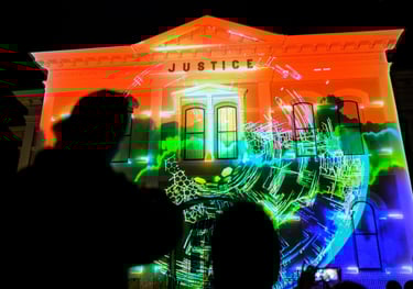 A dramatic nighttime scene where a historic building is brought to life with vibrant 3D Mapping