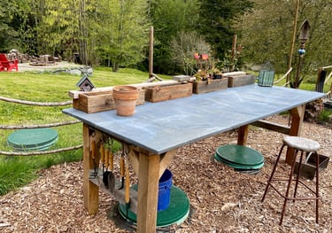 a garden table with pots and tools on it