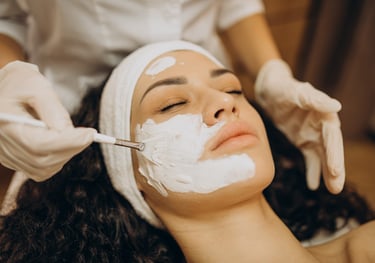 a woman getting a facial in a beauty salon