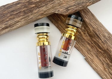 two bottles of perfumes and a wooden cross