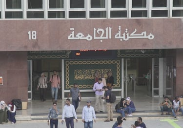 a group of people walking down a street Infront of a library 