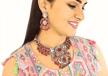 a woman in a pink dress and necklaces