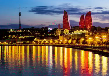a city skyline with a river and a bridge