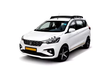 White Maruti Ertiga one way taxi by Saini taxi services with a luggage carrier rack