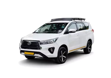 White Toyota Innova Crysta one way taxi by Saini taxi services with a luggage carrier rack