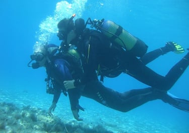 two people are scuba divers in the water
